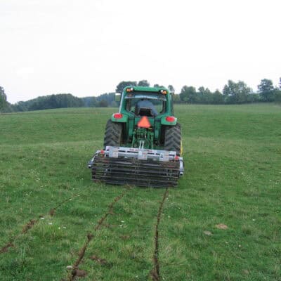 Yeomans plow working fitted fixed shanks and crumble roller also tickle pot seeders, coulters on john deere tractor