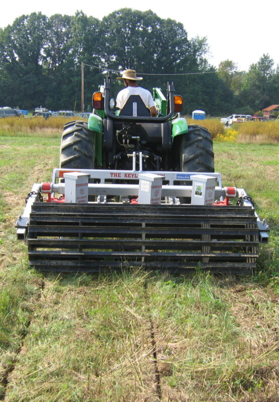 Yeomans keyline plow fitted with tickle pot feeders and crumble roller - on a john deere tractor - subsoil regeneration
