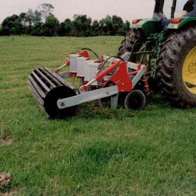 Yeomans plow working fitted fixed shanks and crumble roller also tickle pot seeders, coulters on john deere tractor