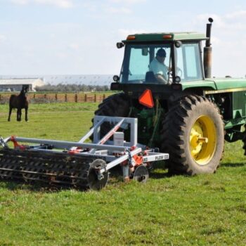 Yeomans plow L4310 5 26 5 18 coulters xarm crumble roller fitted to a john deere - plowing a green grassy field