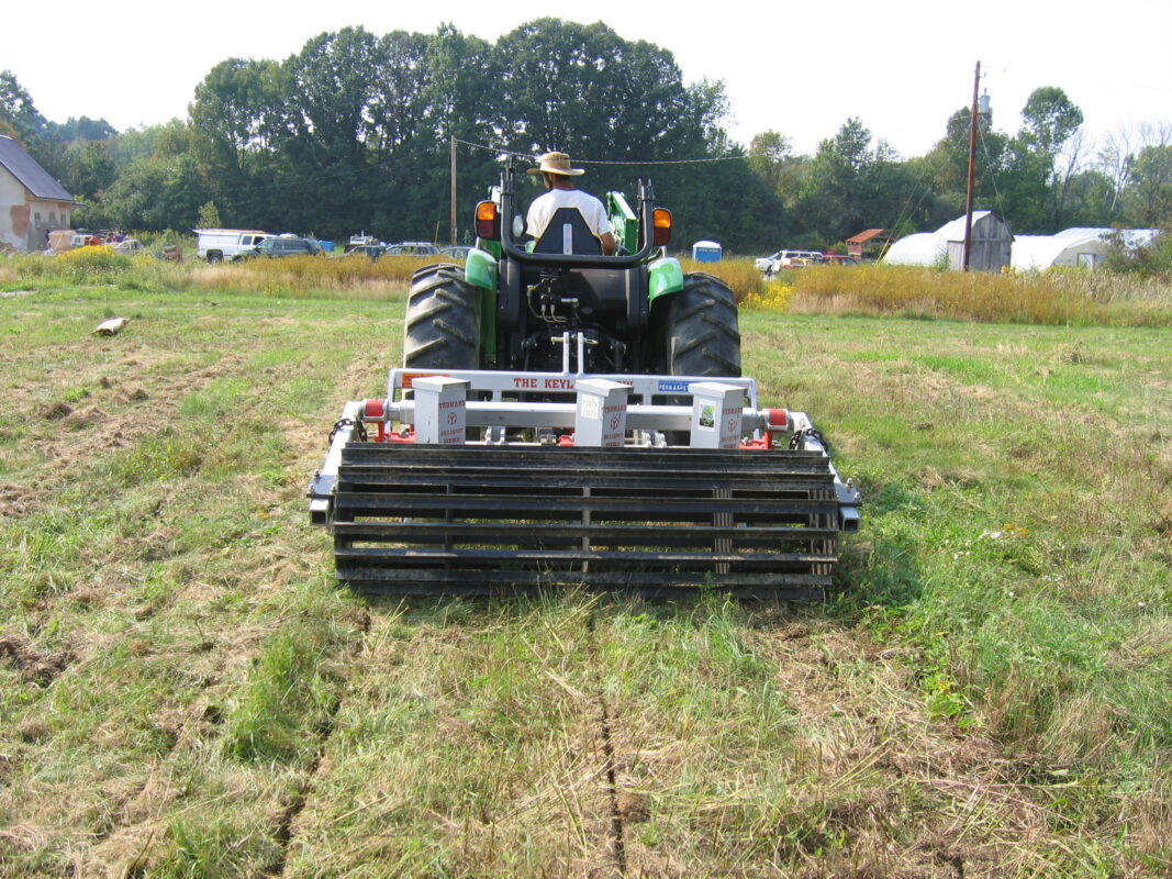 Yeomans keyline plow fitted with tickle pot feeders and crumble roller - on a john deere tractor - subsoil regeneration